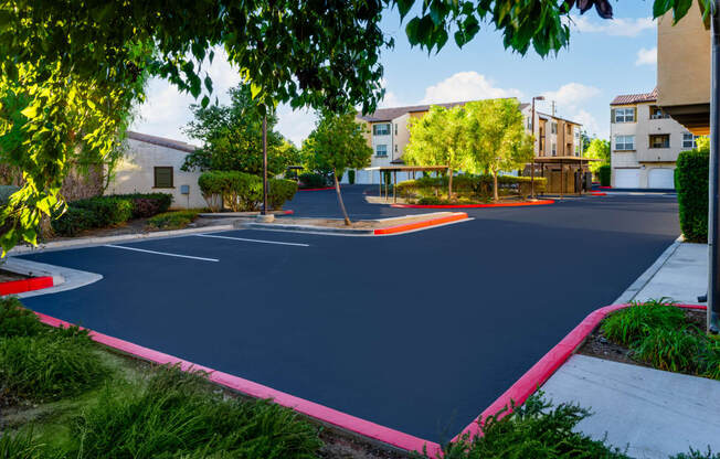 a basketball court in a neighborhood with buildings and trees