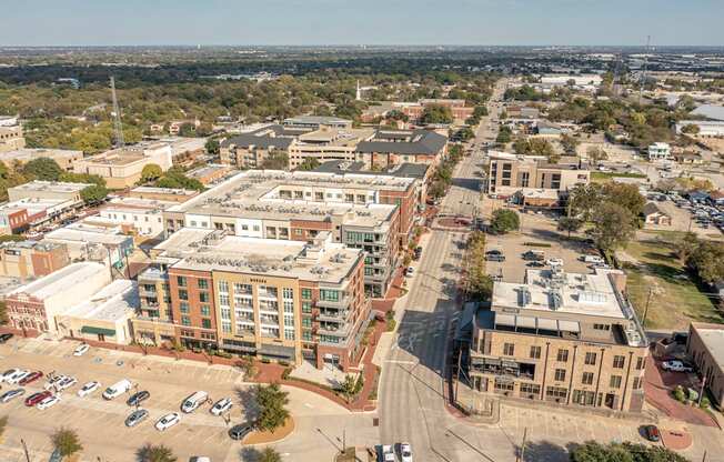 A city street with cars and buildings.