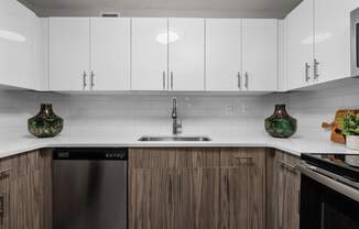 a kitchen with white countertops and wooden cabinets