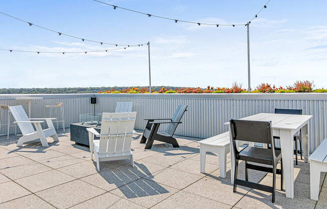 the patio on the top of the building has tables and chairs and views of the