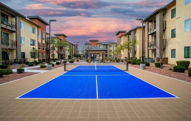 a pickleball court in the middle of an apartment complex