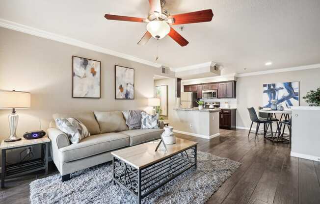 a living room with a couch and a ceiling fan