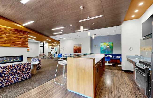 A modern kitchen with a wooden counter and a patterned sofa.