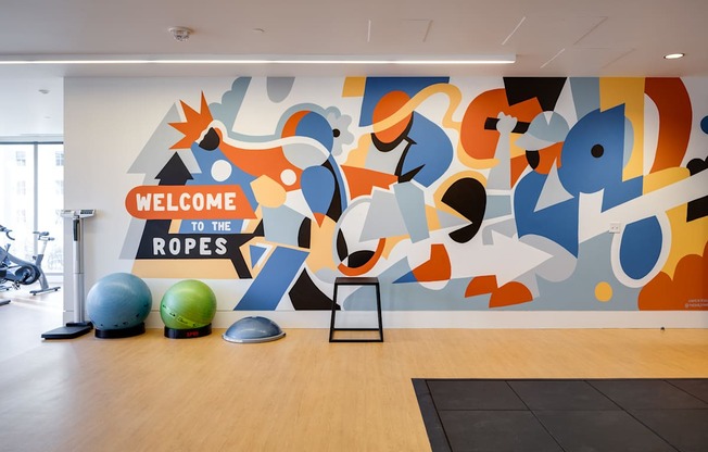 A gym with a sign that says "Welcome to the Ropes".