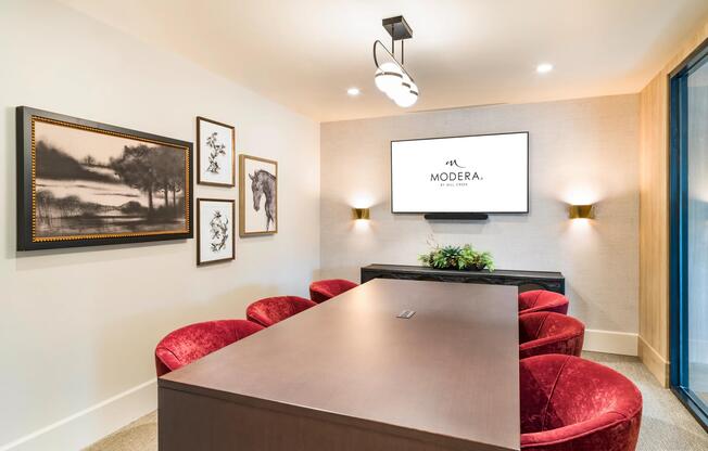 A polished conference room at Modera University Park, ideal for focused conversations and remote work in a refined setting.A private study room at Modera University Park, offering a quiet, design-forward setting for focused work and productivity.