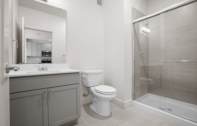 a bathroom with a toilet sink and shower