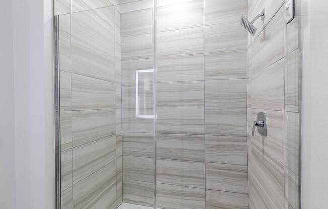 A modern bathroom with a glass shower stall.