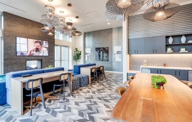 A modern office space with a long wooden table and blue chairs.