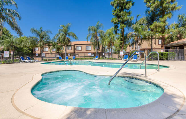 our apartments offer a resort style pool with chairs and trees