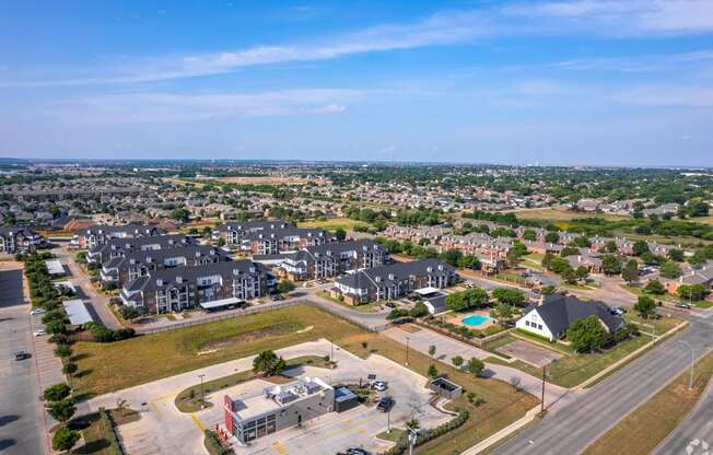 an aerial view of a neighborhood with houses and a parking lot