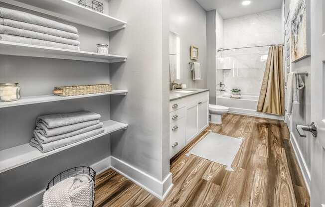 a renovated bathroom with a shower and shelves with towelsat The Overlook, Winter Garden, 34787