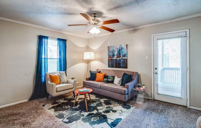 a living room with a couch and a ceiling fan