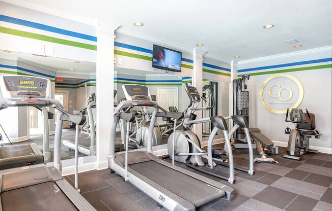 A gym with treadmills and exercise bikes.