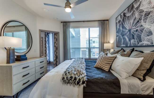 a bedroom with a large bed and a ceiling fan