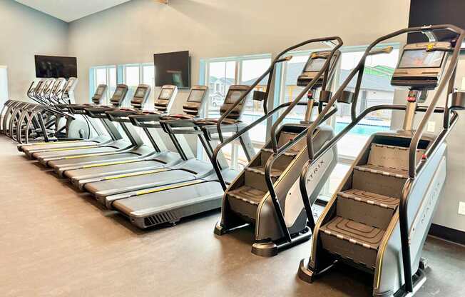 A gym with treadmills lined up.