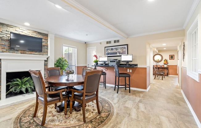 a dining area with a table and chairs and a fireplace