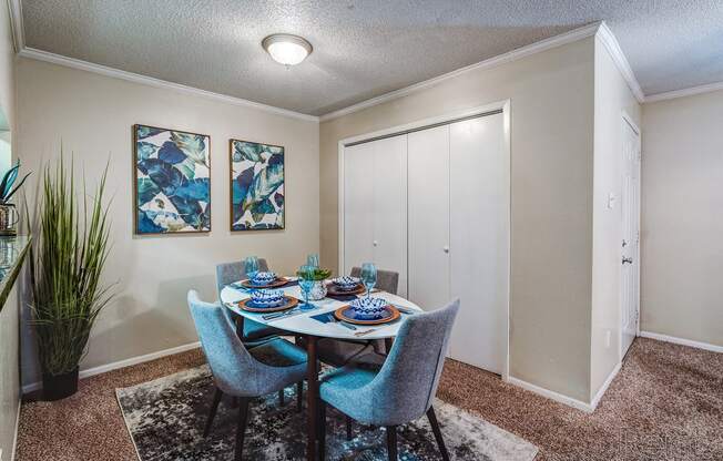 a dining room with a table and chairs