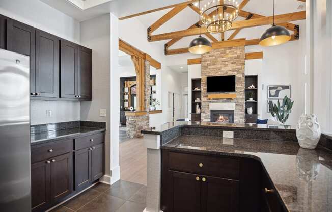 a kitchen with granite counter tops and a fireplace