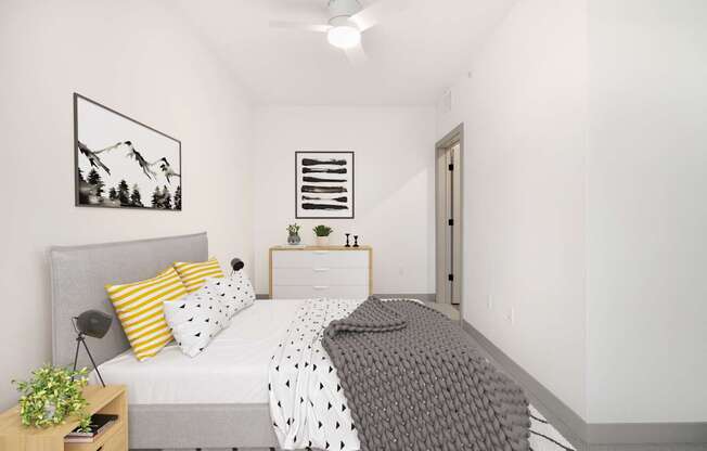 A bedroom with a bed, nightstand, and a mountain picture on the wall.