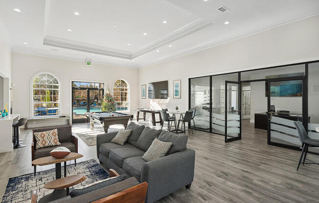 Community Clubhouse with Lounge Furniture and Game Tables at Shadow Ridge Apartments in Riverdale, GA.