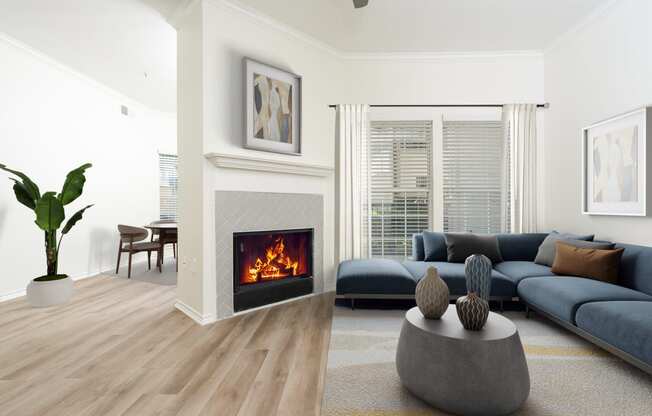 a living room with a fireplace and blue couches