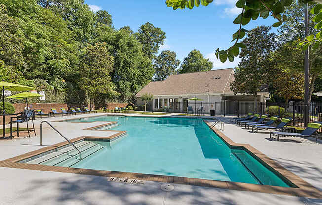 Community Swimming Pool with Pool Furniture at Retreat at Stonecrest Apartments located in Lithonia, GA.