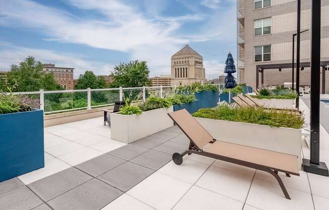 a bench on a roof terrace with a view of the city