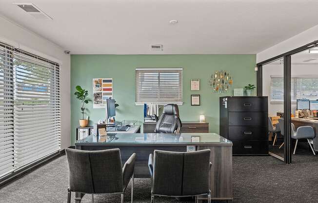 a home office with a desk and chairs