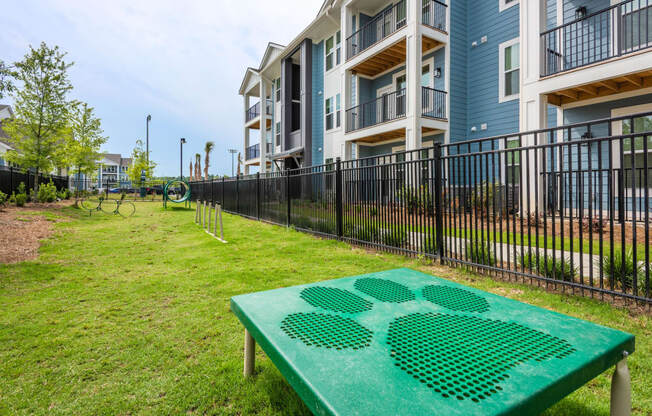 a green ping pong table in front of an apartment building