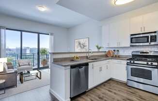 kitchen with stainless steel appliances and living room