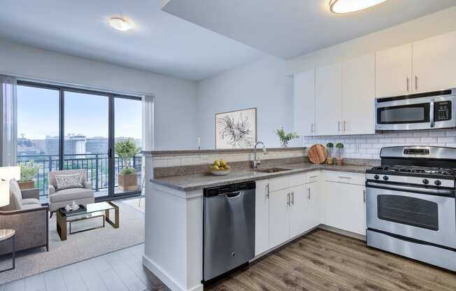 kitchen with stainless steel appliances and living room