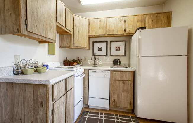 a kitchen with white appliances and wooden cabinets