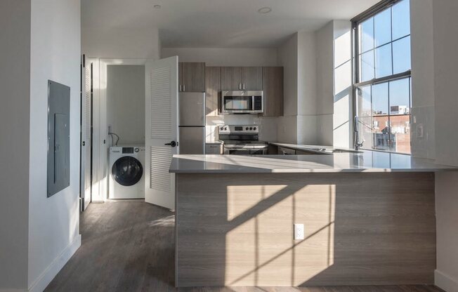a kitchen with a large island and a washing machine