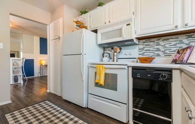 a kitchen with a stove microwave and refrigerator at Village Club of Royal Oak, Royal Oak, MI