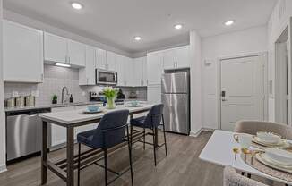 A modern kitchen with a dining table and chairs.