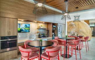 a dining area with chairs and tables and a kitchen