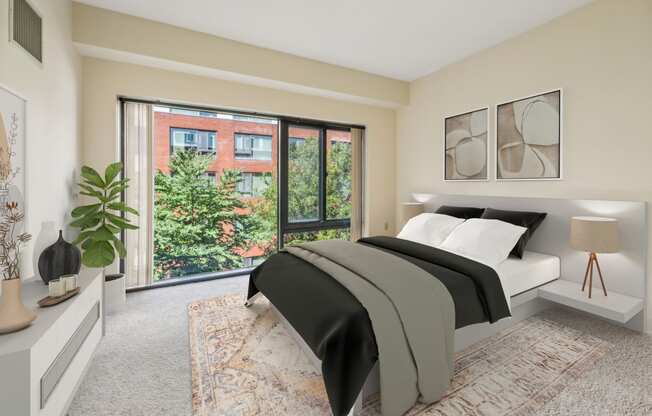 a bedroom with a bed and a large window at Residences at Manchester Place in Manchester New Hampshire