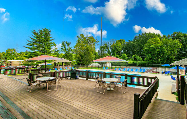 a swimming pool with tables and umbrellas