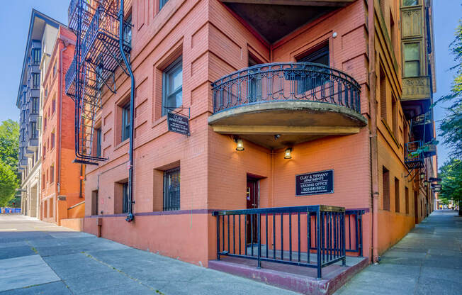 A red building with a balcony and a sign that says "Liberty Street".