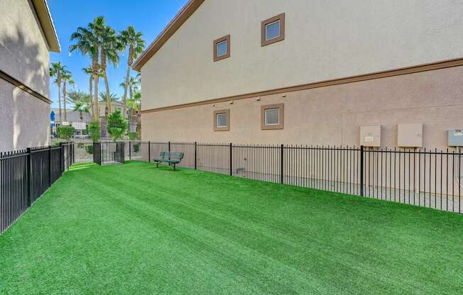 A house with a green lawn and a fence.