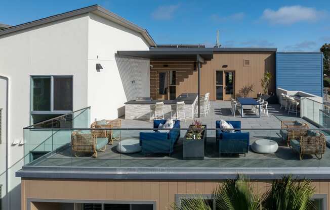 a roof terrace with furniture on top of a house