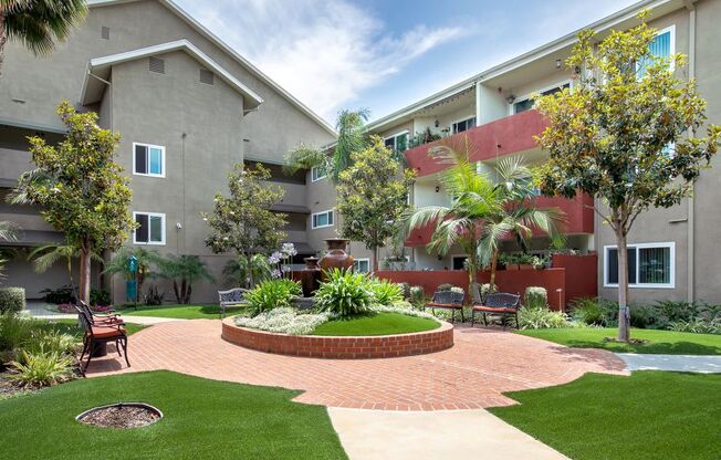 Woodland Hills CA Apartments for Rent - Exterior View of the Property Showcasing Expansive Community and Beautiful Green Landscaping