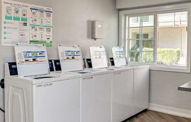 A row of washing machines in a laundromat.