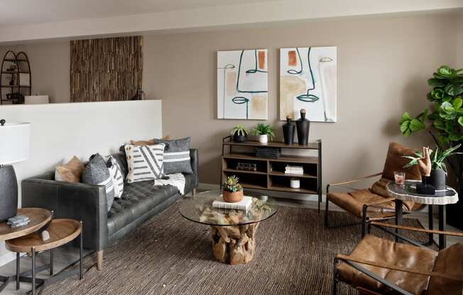 a living room filled with furniture and a large painting on the wall