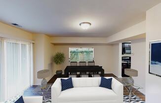 living area with sofa, coffee table, large patio doors and view of dining area at city towns apartments in washington dc