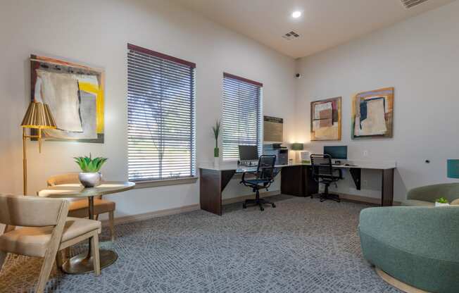 an office with two desks and chairs and a couch