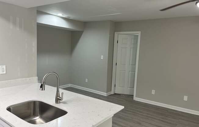 a kitchen with a sink and a ceiling fan at The Hub at 934 Apartments, Georgia, 30349