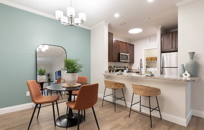 an open kitchen and dining area with a table and chairs