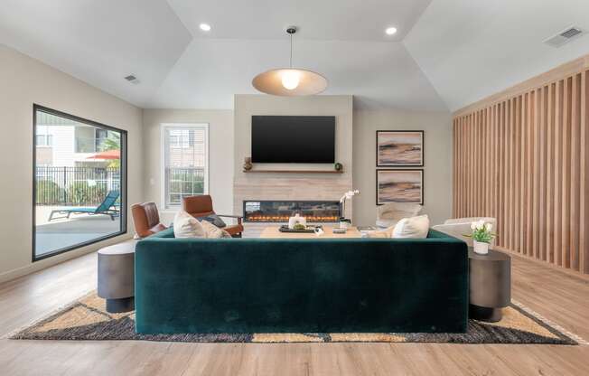 a living room with a green couch and a fireplace