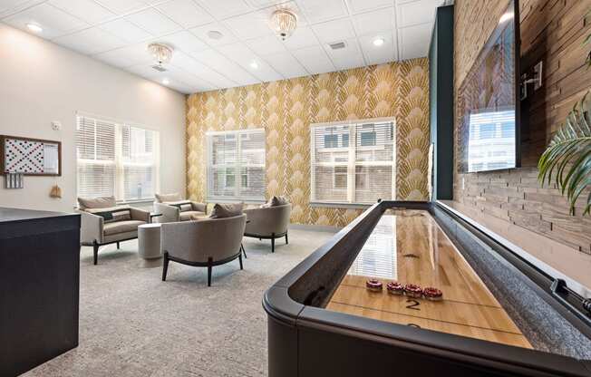 a room with a foosball table and couches